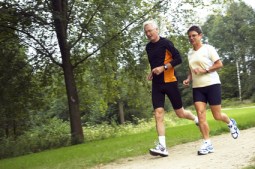 Senior Couple Running In The Woods